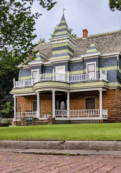 The Fred and Addie Drummond Home photo taken by Trait Thompson. A three story Victorian home with a pointed tower atop