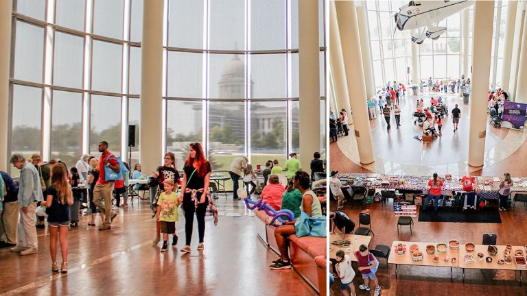 Children and families gather at the Oklahoma History Center talking, visiting tables and looking at the exhibits