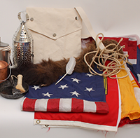 Flags, lanterns, rope, Conquistador helmet, fur pelts, and other objects in the Explorers Trunk