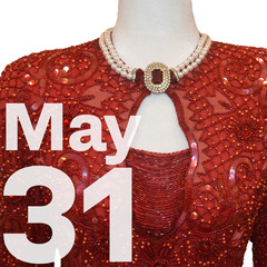 A red sequined ball gown with the date May 31 over the top in large white letters