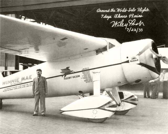 Wiley Post standing in front of the Winnie Mae of Oklahoma airplane on July 22, 1933 after his Around the World Solo Flight