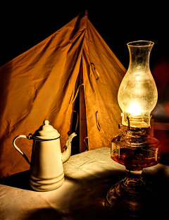Photos of night encampments at Honey Springs, Fort Towson, and Doaksville. Photos depict tents with lights and candlelight over a night sky