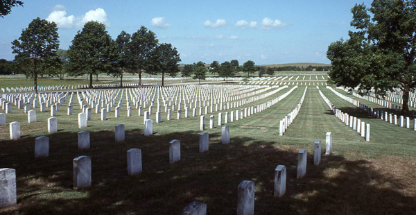 The Fort Gibson cemetery with rows upon rows of marble headstones as far as the eye can see. Blue skies and trees