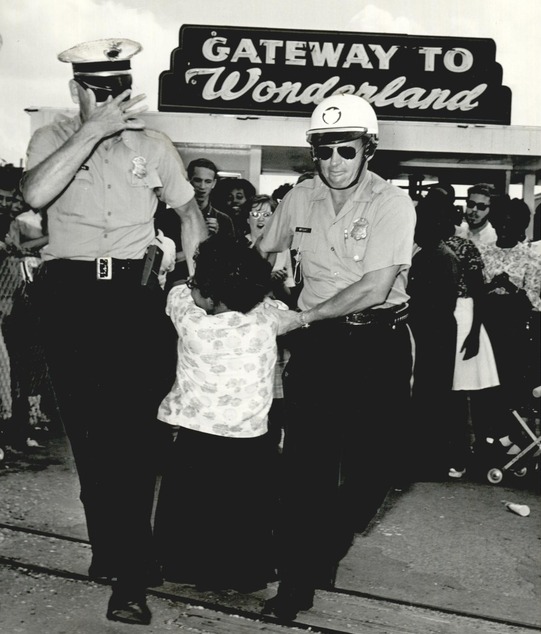 Marylin Luper is dragged by the arms away from the Wedgwood Village Amusement Park in 1963, protesting segregation.