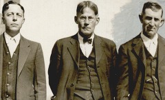 Three men dressed in suits and ties look directly at the camera, photo taken in the 1930s.