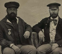A historic photo taken of Kenny Sivard and T. S. Akers wearing period uniforms, medals, and hats from the Civil War era