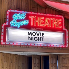 A sign outside the Will Rogers Movie Theater that shows a lit marquee and the words "Movie Night"