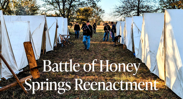 Honey Springs reenactment site with tents to either side and living history actors walking  through. Honey Springs logo