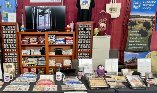 OHS State Fair Booth with merchandise, posters, maps, books and cards displayed in racks and on the table