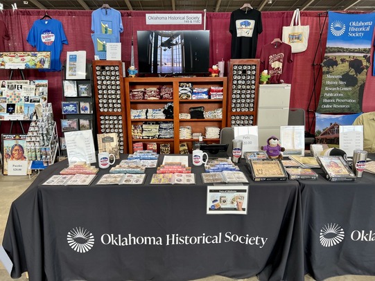 OHS State Fair Booth with merchandise, posters, maps, books and cards displayed in racks and on the table
