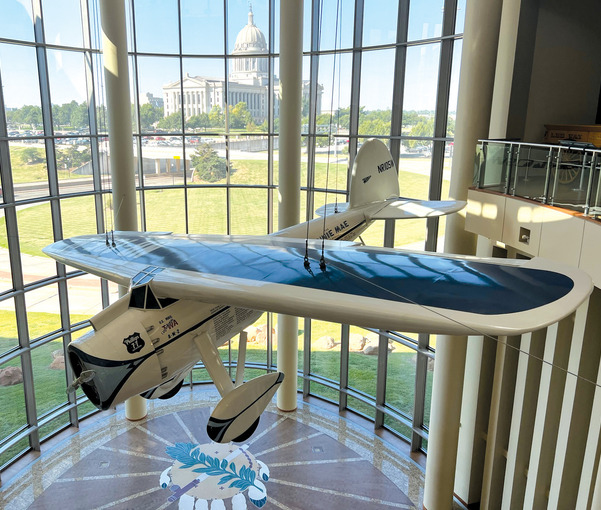 The Winnie Mae airplane suspended in the Oklahoma History Center great hall.