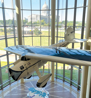 The Winnie Mae airplane suspended in the Oklahoma History Center great hall.