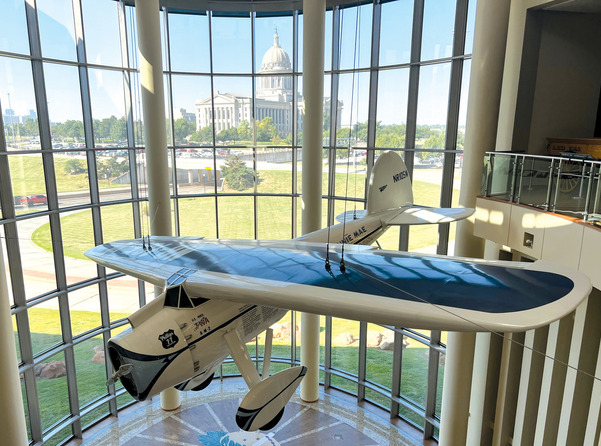 The Winnie Mae airplane suspended in the Oklahoma History Center great hall.