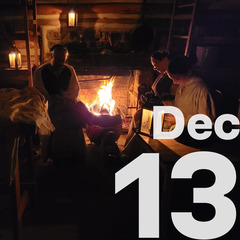 A group of women sit at the hearth fire sewing.