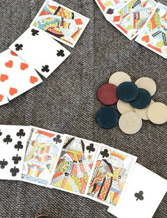 Civil War era playing cards arrayed on a blanket with chips.
