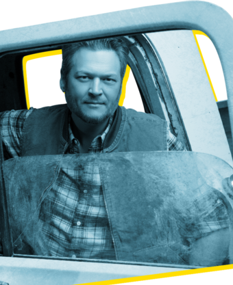 Country Western music star Blake Shelton looks through the window of an open truck door.
