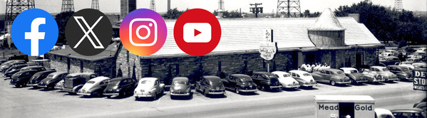 Route 66 restaurant with over thirty cars parked around its outskirts.