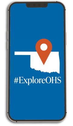 A cell phone with a pinpointed map of Oklahoma centered on the phone