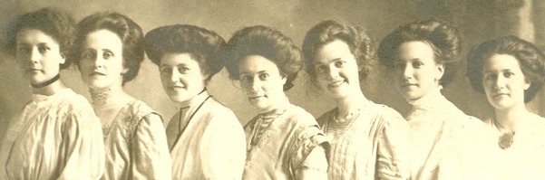 Vintage photo of women grouped together for a photo, with names written at a diagonal below.