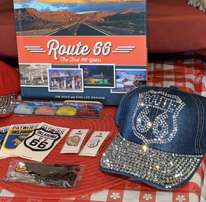 Baseball caps with sequined design of Route 66 logo, Route 66 patches, stickers, and store merchandise about Route 66.