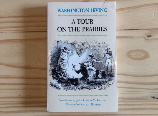 A book  'A Tour of the Prairies' by Washington Irving sitting on a table.