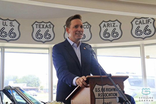 Lt. Governor Matt Pinnell gives a speech at a podium at the Oklahoma Route 66 Museum.
