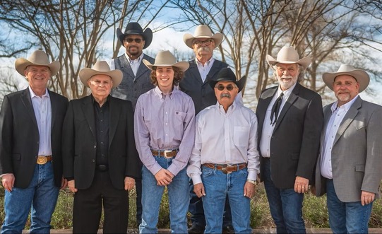 A group of men dressed in Cowboy hats and Western wear