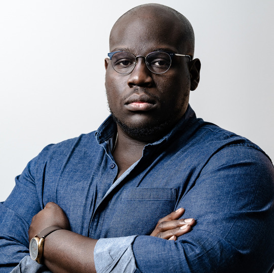 Black Moses book cover and a portrait of the author Caleb Gayle, wearing a denim shirt with his arms crossed.