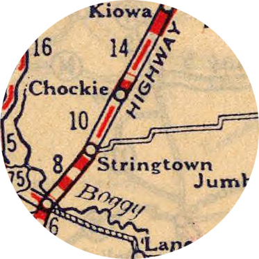 Detail of a printed map depicting Stringtown Oklahoma along a highway.