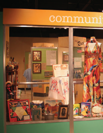 An exhibit designed as a community thrift store window and kiosks.