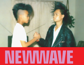 Two teenagers with high 80s style mohawk hair shake hands