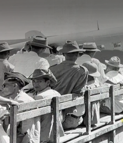 Vietnamese seated in the back of a truck awaiting a plane.
