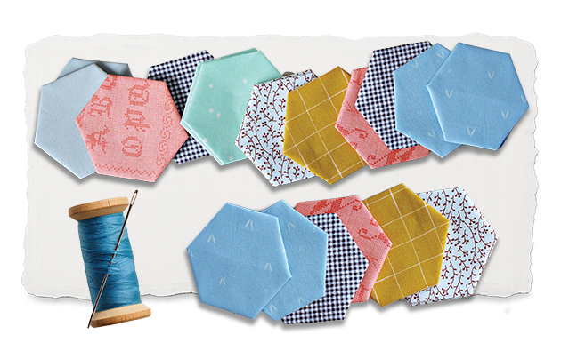 Hexagonal pieces of an applique quilt of various calico pattern and color and a spool of thread.