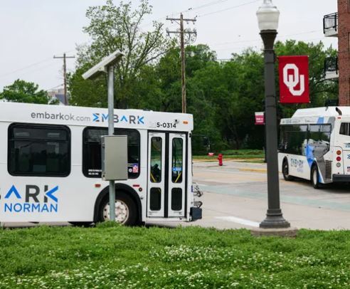 OU Norman buses by OU flag pole.