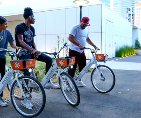 Three people sitting on Spokies ebikes at Myriad Gardens.