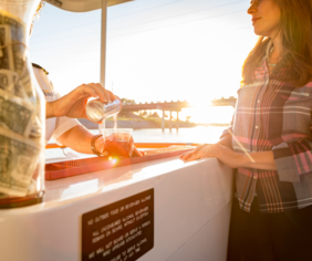 Woman standing at bar aboard OKC River Cruises