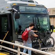 rapid nw bus with person loading bike onto front rack