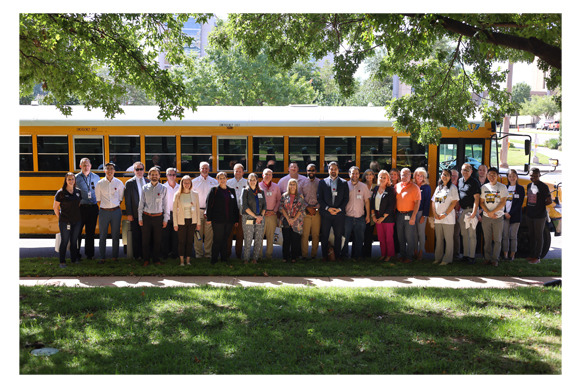 NSF Grant partners stand next to electric bus