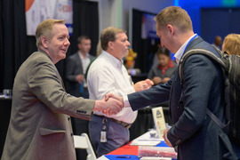 Staff shaking hands with expo attendee