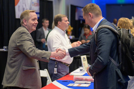 Expo staff member and attendee shaking hands