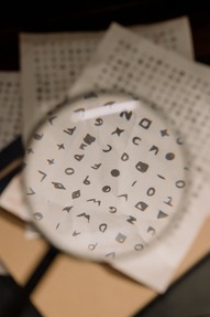 Magnifying glass over a paper with code