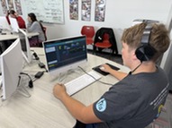 Student sitting at computer participating in coding activities.  