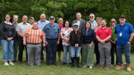 Stakeholders for Logan County RWD 1's groundbreaking pose for a group photo.