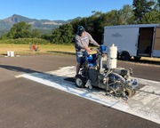 Staff on painting machine painting runway markings