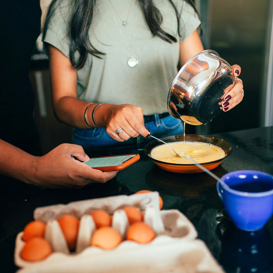 A photo showing a person cooking breakfast. 