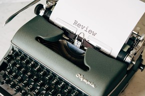 Old fashioned typewriter with the word review typed on the page