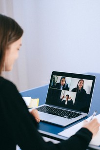 woman at computer participating in a virtual meeting