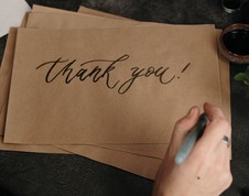 Thank you written in marker on a brown piece of paper