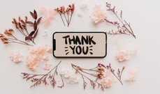 The words Thank You surrounded by flowers