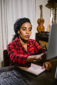 Woman sitting at desk looking at computer monitor